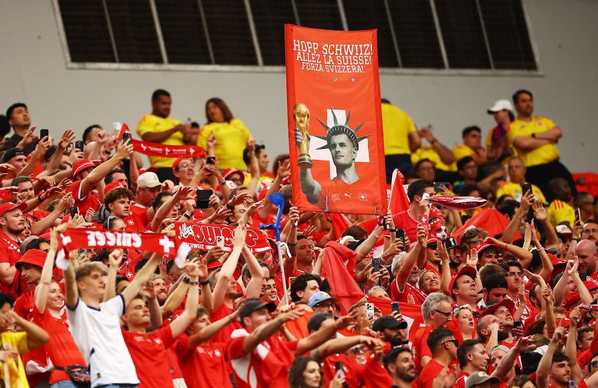 The Swiss red tide lights up the stadium: HOPP SCHWIIZ toward the quarterfinal against Argentina.