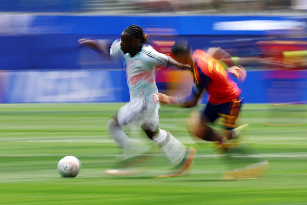 Belgium and Spain players blur through a fast duel during the quarter-final