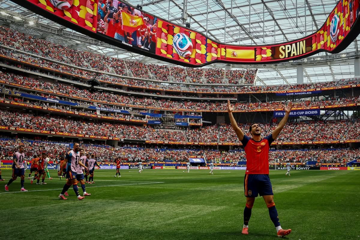 Spain player celebrates in a packed stadium after the quarter-final against Belgium