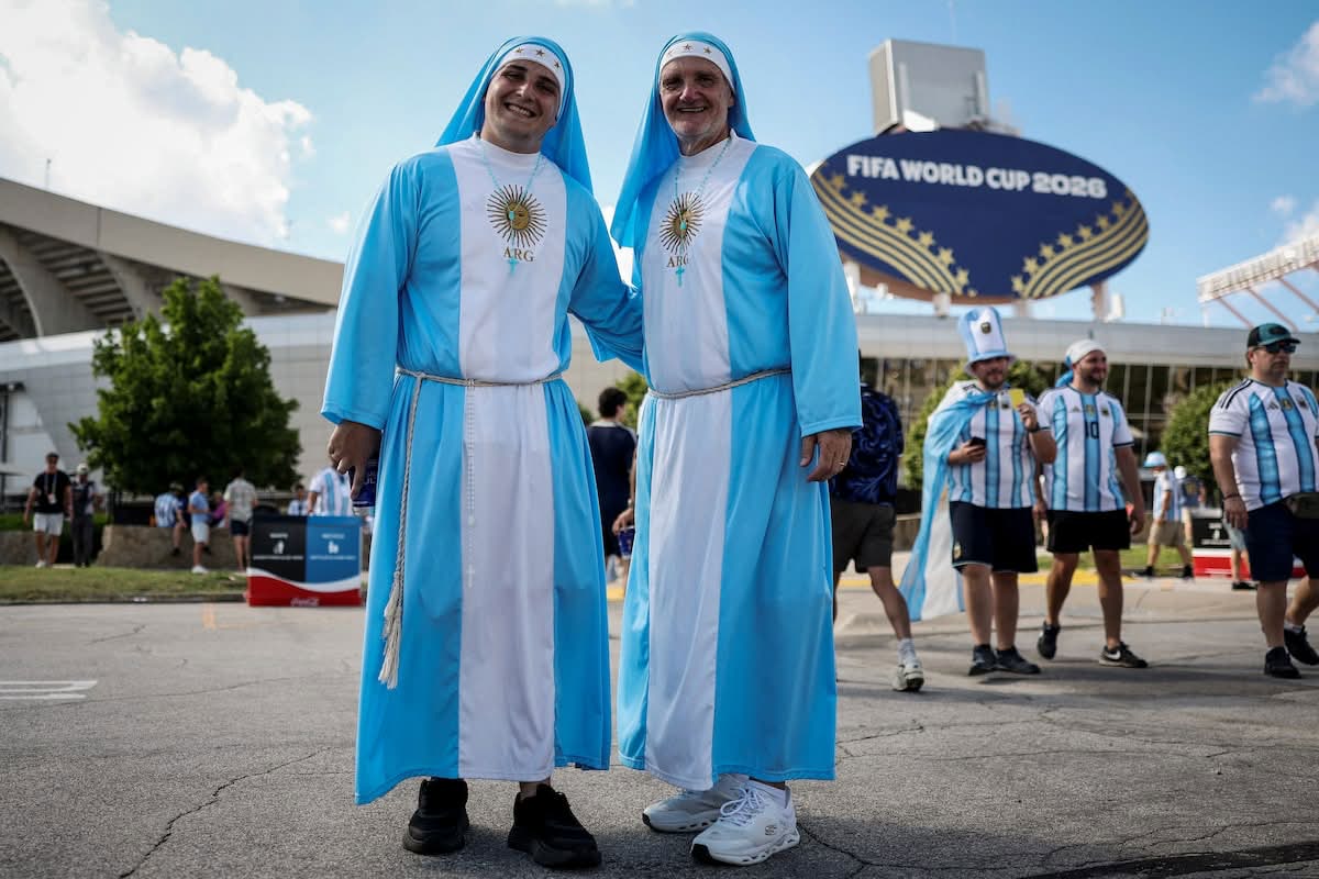 Argentina fans dressed as nuns pose outside the stadium before the quarter-final