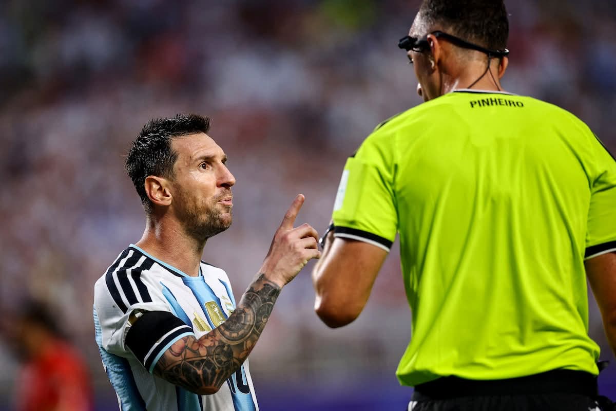 Lionel Messi makes his case to referee Pinheiro during the quarter-final