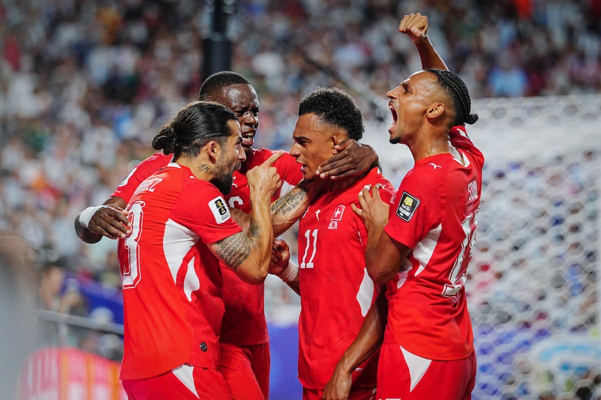 Switzerland players celebrate Dan Ndoye's equalizing goal in a group huddle